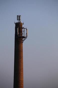 Old chimney used as a base for radio transmitters photo