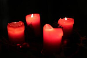 Four red christmas candles with selective focus effect photo
