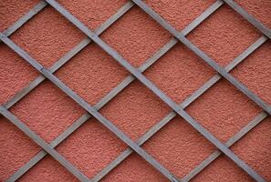 Wooden trellis on an orange wall photo