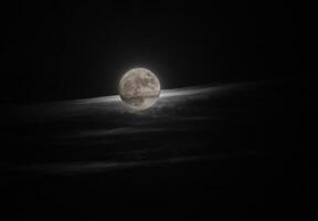 Full moon behind a cirrus cloud made visible by an HDR imaging technique. photo