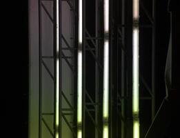 Illuminated panel ripped off showing the fluorescent tubes inside. They create a red and green light effect. photo