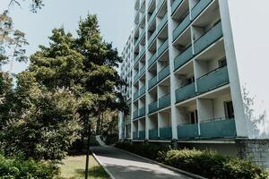 Multi quiet storey residential building suburb city, house background sunny summer day photo