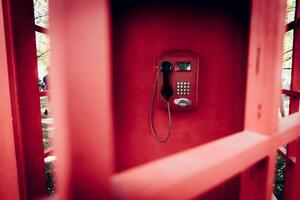 Old Red City Phone Booth, Analog Phone with Dial and Big Handset photo