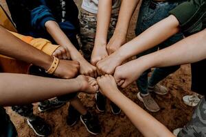 Group people banging fists in circle, team friend touch hands, teamwork together photo