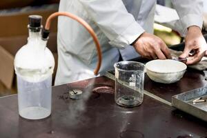 Scientist in laboratory smart pour liquid glass flask, assistant conduct an experiment photo