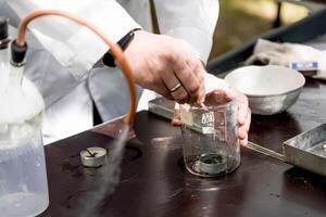 Scientist in smart laboratory pour liquid glass flask, assistant conduct an experiment photo