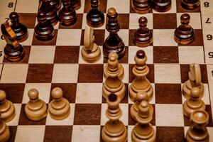 Chessboard with chess pieces top view, board game for two photo
