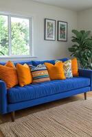 Blue Sofa With Orange And Patterned Pillows In A Room photo