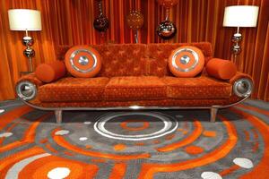 Orange Velvet Sofa with Circular Pillows in Retro Setting photo