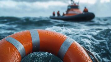 A bright orange life ring floats perilously in the deep ocean during a critical rescue operation, highlighting the urgent need for prompt and effective action to save lives at sea during emergencies photo