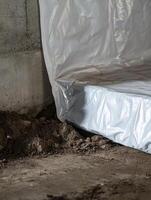 A vapor barrier effectively placed in a crawl space is essential as it prevents moisture from damp soil, thereby protecting your home from potential water damage and the subsequent growth of mold photo