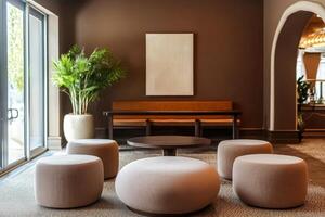 The lobbys chic warm mocha tones, along with the plush ottomans, modern table, and elegant decor, all come together to create a cozy and inviting atmosphere that welcomes guests comfortably photo