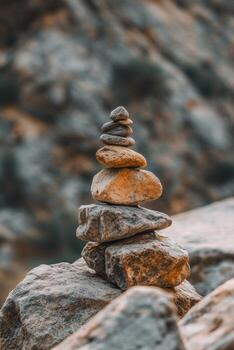 Stacked stones balancing on rocky terrain in a natural setting photo