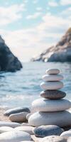 Balanced stones stacked on a beach near a calm sea under clear sky photo
