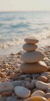 Balanced stones create a tranquil centerpiece on a beach shore photo