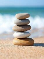 Stacked stones by the ocean create a tranquil beach view photo