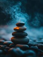 Stacked stones emitting smoke in a tranquil setting during dusk photo