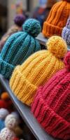 Colorful knitted hats displayed on a market shelf during winter season photo