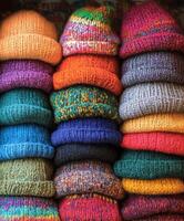 Colorful hand-knitted hats arranged neatly in a cozy shop display photo
