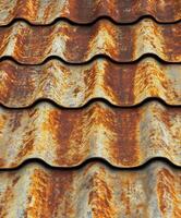 Weathered metal roofing showcases vibrant rust patterns in urban setting photo