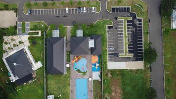 An aerial view of a residential complex with a swimming pool photo