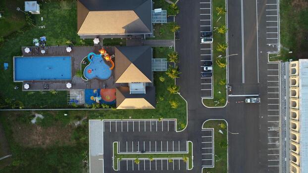 An aerial view of a residential area with a swimming pool photo