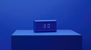 Digital clock displaying time in a serene blue setting on a minimalist platform photo