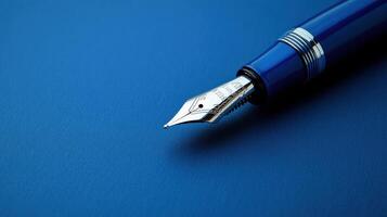 Fountain pen with elegant design resting on a blue surface during a creative workspace session photo