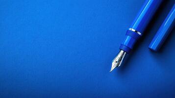 Elegant blue fountain pen on a vibrant blue background showcasing artistry and craftsmanship in writing instruments photo