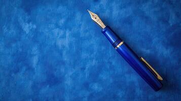 Elegant blue fountain pen rests on a textured blue background, inviting thoughts and creative expression in a peaceful setting photo
