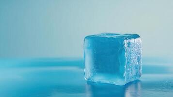 Ice cube with a blue tint resting on a smooth surface in a bright setting photo