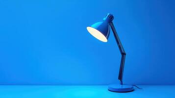 Bright blue desk lamp illuminating a workspace with a calm ambiance in a modern setting photo
