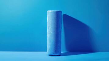 Unique cylindrical object displayed against a vibrant blue background showcasing minimalist design and artistic presentation photo