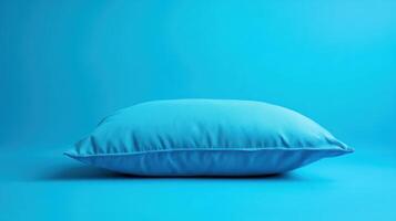 Soft blue pillow resting on a flat surface with a vibrant background during daylight photo