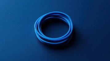 Blue rubber bands arranged in a circular shape on a dark background creating contrast and simplicity photo