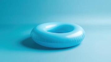 Bright blue inflatable pool float resting on a soft blue background, creating a serene atmosphere perfect for summer relaxation and enjoyment photo