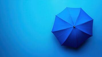 Bright blue umbrella against a solid blue background creating a calming and minimalist aesthetic in a modern setting photo