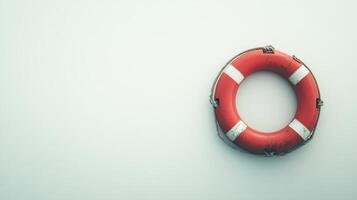 Lifebuoy floating against a calm backdrop illustrating safety measures in aquatic environments during daylight photo
