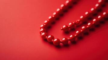 Striking red beads arranged elegantly on a vibrant red backdrop showcasing texture and color harmony photo