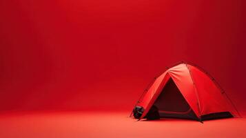 Red camping tent set up indoors with a vibrant background providing an artistic atmosphere for outdoor enthusiasts photo