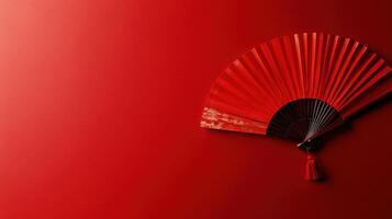 Elegant red fan displayed against a vibrant background enhances traditional aesthetics and cultural significance photo