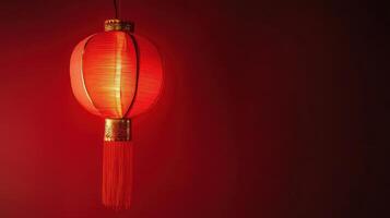 Bright red lantern hanging against a dark wall, adding a touch of warmth and tradition to the space photo