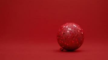 Sparkling red ornament resting on a solid red background creates a festive atmosphere for the holiday season photo