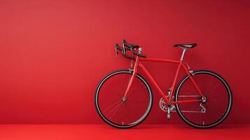 Bright red bicycle leaning against a vibrant red wall in a minimalist setting, showcasing design and color contrast photo
