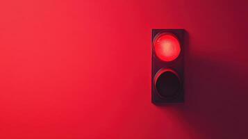 Bright red traffic light signals to stop on a minimalistic background during daylight hours in a modern urban setting photo