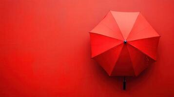 Bright red umbrella against a vibrant red wall creating a striking visual contrast photo