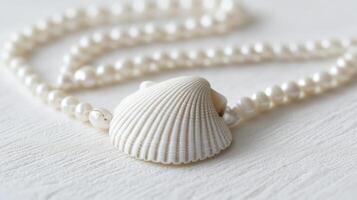Beautiful necklace featuring a seashell pendant on a string of pearls in a bright and elegant setting photo