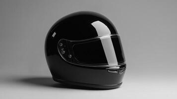 Black motorcycle helmet displayed on a clean surface against a neutral background for showcasing design and safety features photo