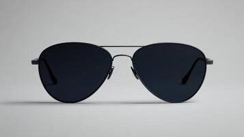 Stylish black aviator sunglasses placed on a smooth surface showcasing modern design with no reflections or distractions photo