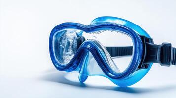 Transparent blue snorkeling mask resting on a white surface ready for aquatic adventures at the beach photo